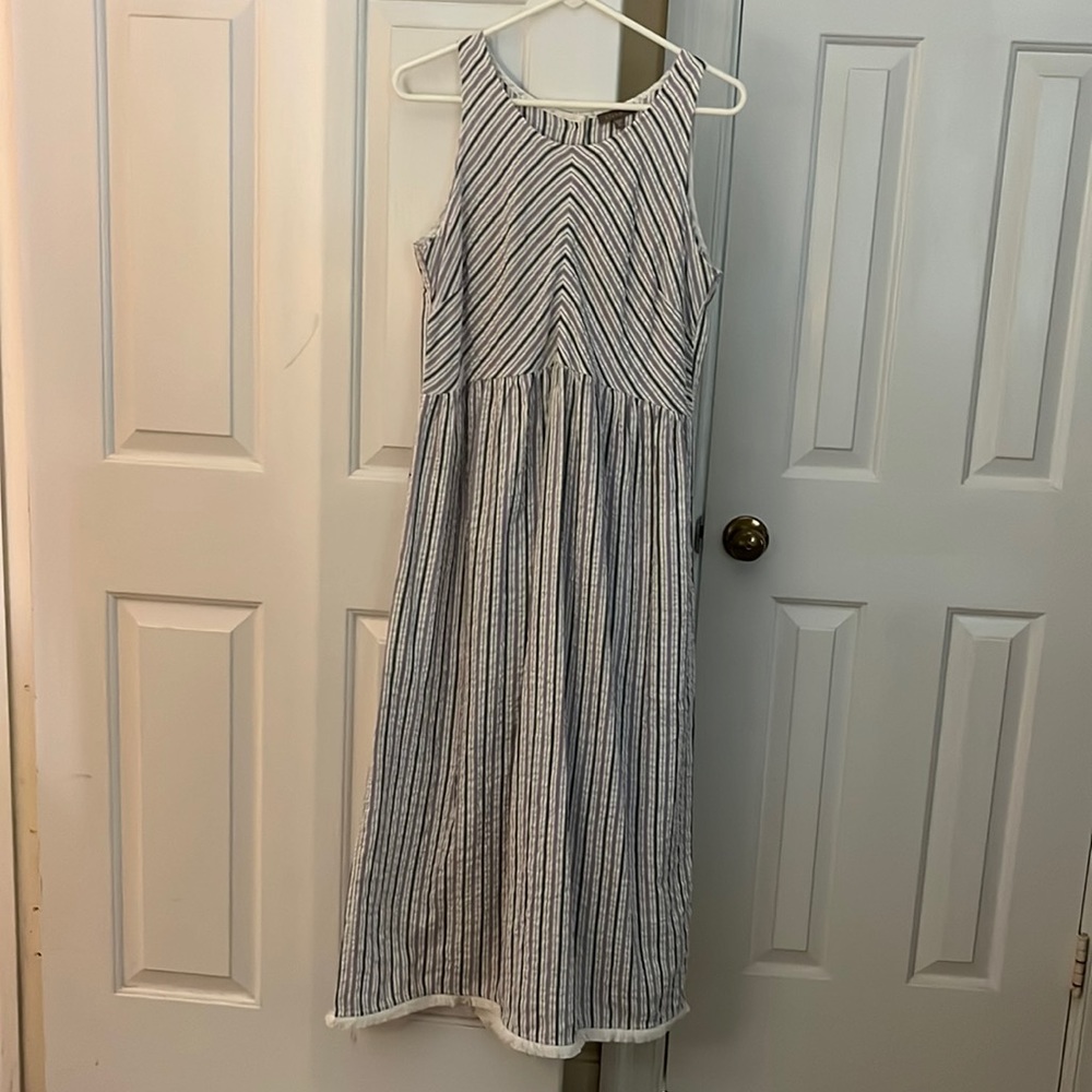 Sleeveless maxi dress, buttons down back.